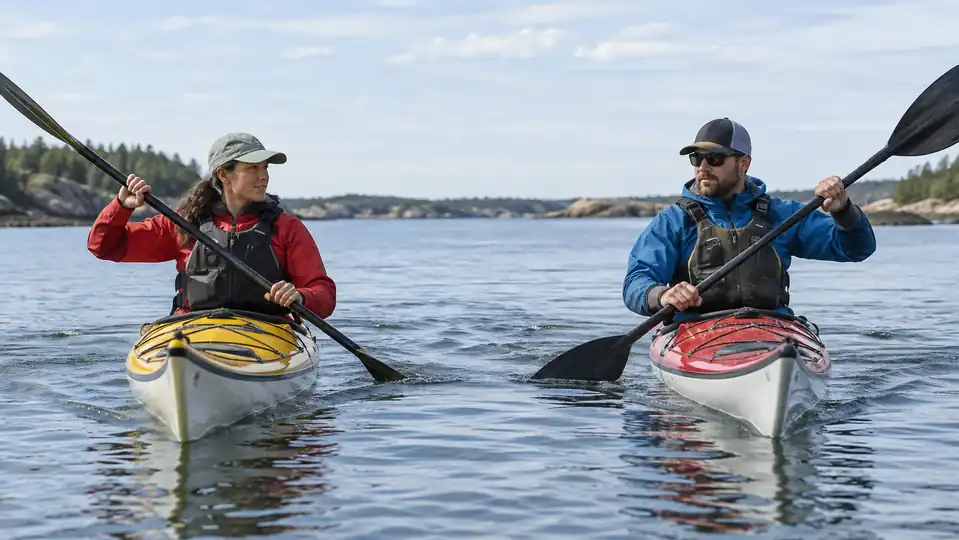 Sea kayakers comparing narrow touring and broad high-angle paddle blades