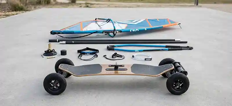 land windsurfing equipment with wheeled board and sail